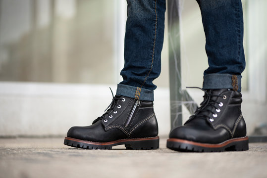 The men model wearing jeans and black boots leather with zipper for man collection.