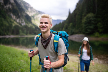 Hiking with friends is so fun. Group of young people with backpacks hiking together