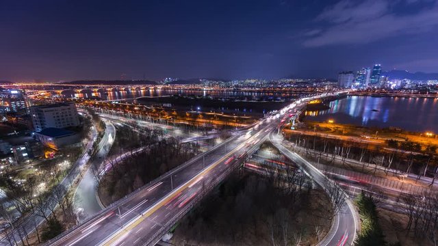 Time lapse of bridges and Cars passing in intersection, Han Riverside at Night in Downtown Seoul, South Korea. 4K