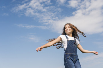 Medium shot little girl with long hair smiling