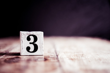 Number 3 isolated on dark background- 3D number three isolated on vintage wooden table