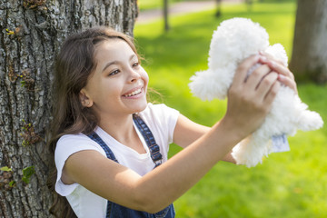 Girl holding with a stuffed toy