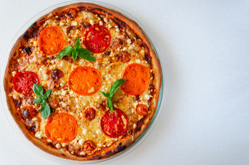 Pizza Margherita with yellow, red and cherry tomatoes, mozzarella cheese, ricotta and fresh basil on white background
