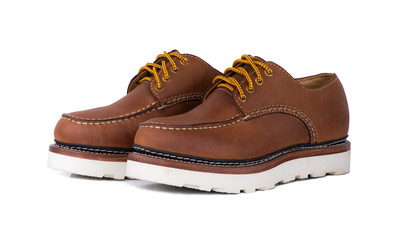 Man fashion close-up a pair of brown shoes isolated on a white background.