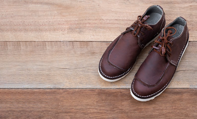 Men fashion of brown shoes on wooden background. Flat lay, top view