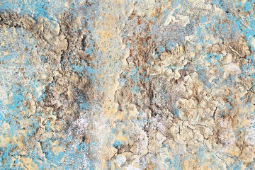 Detailed close up view of aged and weathered concrete walls with cracks and paint in high resolution