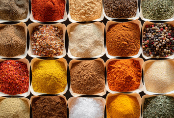 Herbs and spices in bowls background. Cooking flavors
