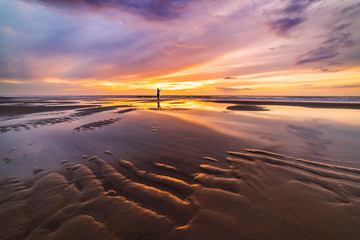 Tourist hand holding smart phone and taking photo of beautiful beach