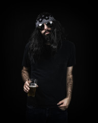 Hippie rocker with long black hair and a bandanna, holding a beer. Set against a dark black background.