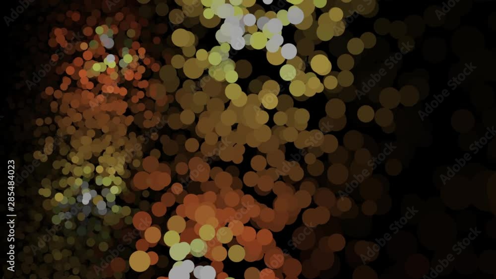 Poster lots of shimmering multicolored particles appearing, floating and fading on the black background. an