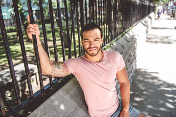 A sexy man outside in a city street