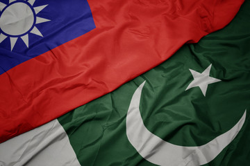 waving colorful flag of pakistan and national flag of taiwan.