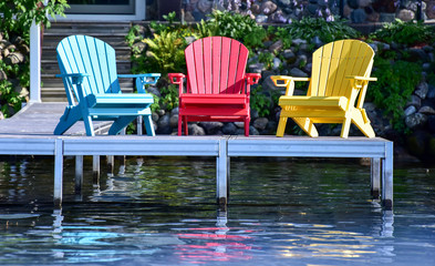 Empty chairs along the lakeshore