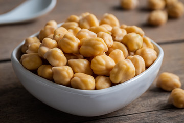 Cooked chick peas in white bowl.