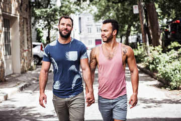 A Portrait of a happy gay couple outdoors in urban background