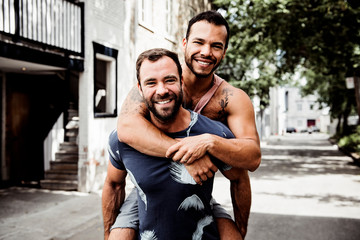 A Portrait of a happy gay couple outdoors in urban background