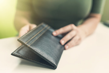 Cropped image of  woman hands with folder and bill on the table of cafe. visitor of restaurant ready to pay