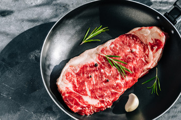 New York raw sirloin steak in a pan top view