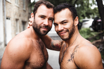 A Portrait of a happy gay couple outdoors in urban background