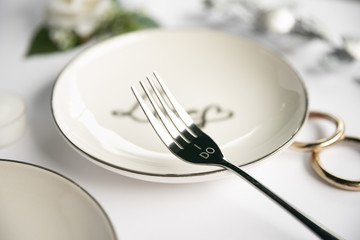 Close-up fork with wedding rings