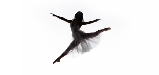 panoramic shot of young graceful ballerina jumping while dancing isolated on white - obrazy, fototapety, plakaty