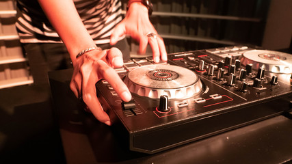 portrait of a male with hat Disc jockey or dj playing turn table, mixer, music
