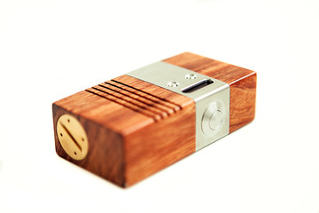 Vaping mod in wooden box isolated in white background