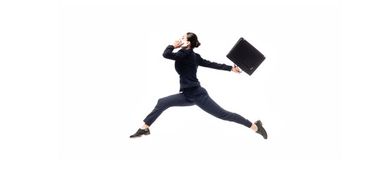 panoramic shot of young businesswoman with briefcase levitating while talking on smartphone isolated on white