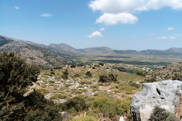 Fototapeta na wymiar Crete, Greece, June 2019. A view of the Lasithi Plateau from above in the Lasithi Mountains of central Crete.