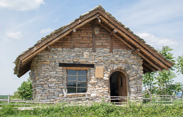 Fototapeta na wymiar Old stone hut with a fence - Image