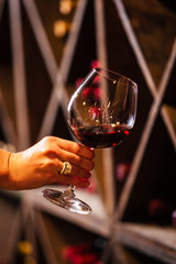 Toasting a wine glass in a wine cellar.