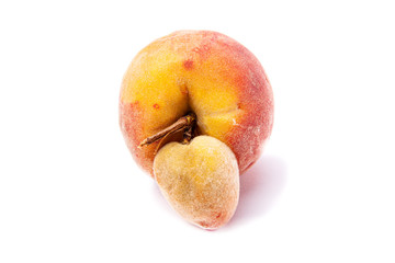 Trendy ugly food. Peach orange fruit isolated on white background. Misshapen produce, food waste problem concept.