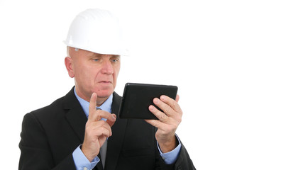 Image with Preoccupied Businessman Wearing Hardhat and Using Electronic Tablet