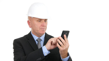 Image with Businessman Wearing Helmet and Texting Using Cellphone Communication