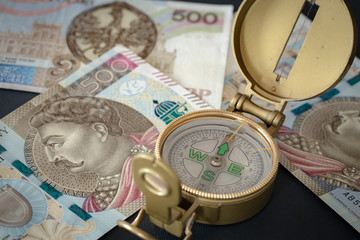 Polish money, 500 zloty with an old compass / business concept