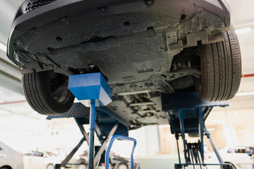 Professional car mechanic changing motor oil in automobile engine at maintenance repair service station in a car workshop.Automobile metal car engine part details.Engine oil change.Car repair.