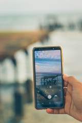 Taking photo of a broken bridge in the sea