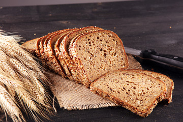 freshly baked bread on wooden board. cutted organic bread