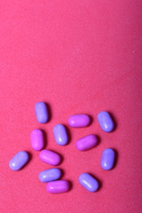 Dragee for refreshment of breath. Among on a coral background.