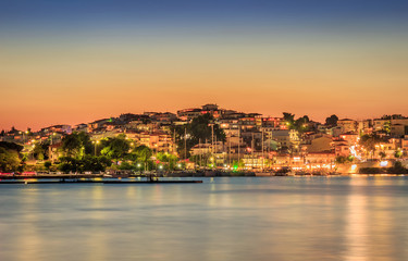 Obraz premium Amazing Neos Marmaras cityscape and harbor sunset with reflective, silky, sea water