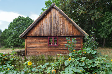 Old wooden house with garden in open-air museum in Osiek village. Poland, Europe