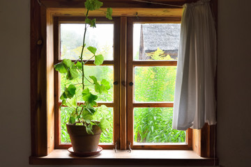 Window of old wooden farmstead in The Folk Culture Museum in Osiek by the river Notec.