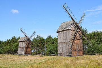 Naklejka na ściany i meble Old wooden windmills in The Folk Culture Museum in Osiek by the river Notec, the ethnographic park covers an area of 13 ha. Poland, Europe
