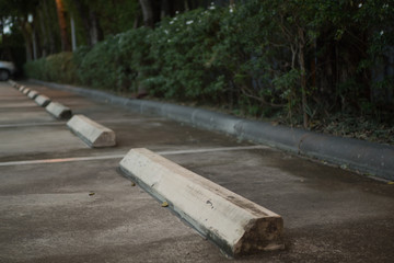 Concrete wheel stopper at outdoor car parking 