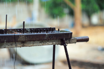 Selective focus on the old wet steel bar in rainy day
