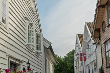 Stavanger white traditional houses with Norwegian flag in old town, Norway