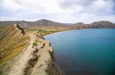 The black sea coast in the Crimea, in Koktebel on the Cape Chameleon at sunset