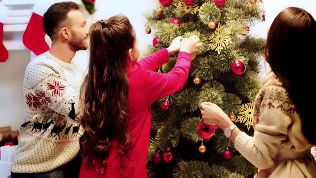 happy family decorating christmas tree 
