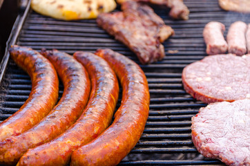 Grilled sausages on barbecue grill.