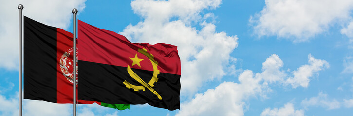 Afghanistan and Angola flag waving in the wind against white cloudy blue sky together. Diplomacy concept, international relations.